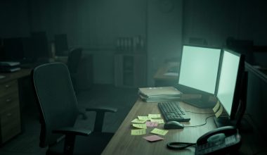 Empty IT support desk in a small CPA firm at night with monitors still glowing